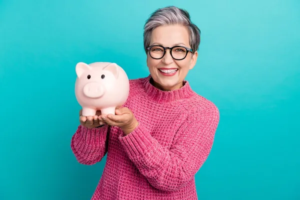 Woman holding a piggy bank